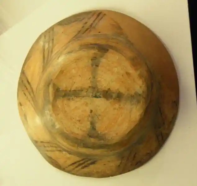 Solar disc with cross in the center on a dish